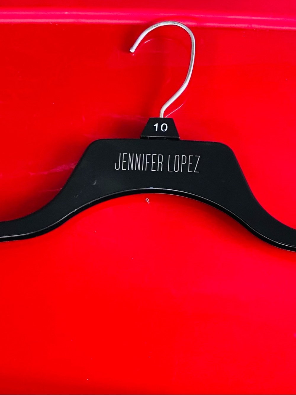 Jennifer Lopez Black Wooden Hanger with Size Tag